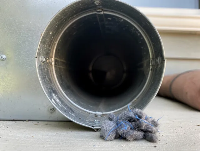 Upper Arlington Dryer Vent Cleaning technician using specialized equipment to clear severe dryer vent blockage in Upper Arlington